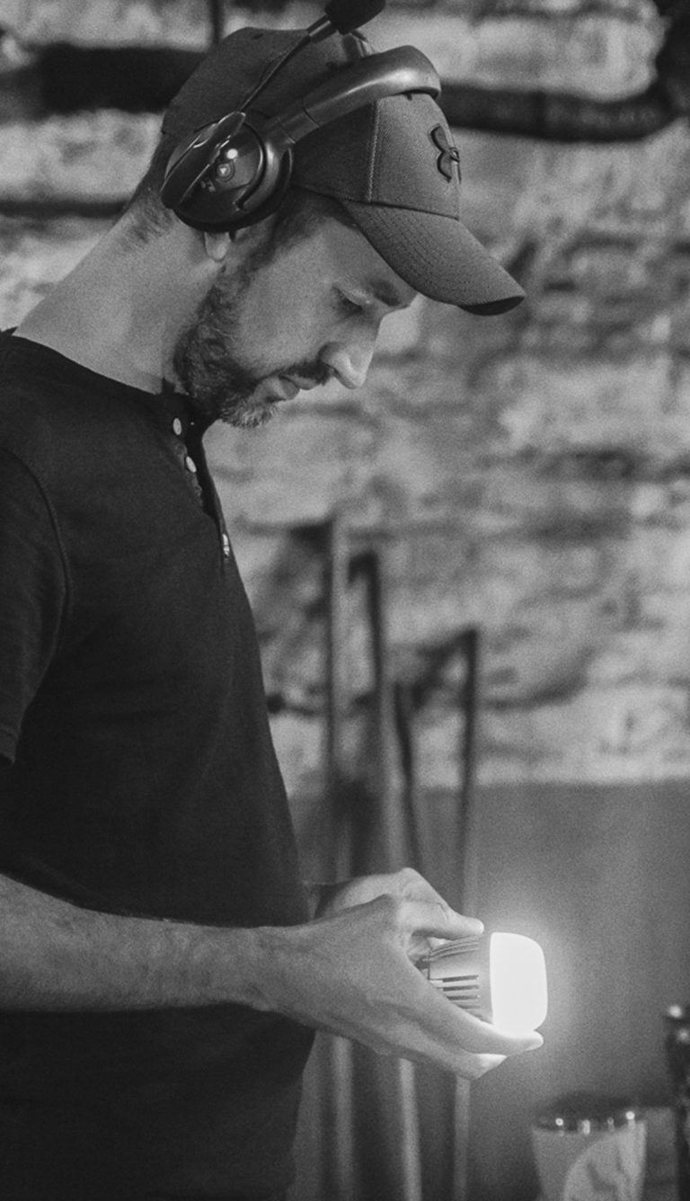 Lighting Camera Operator switching on a Aputure MC light